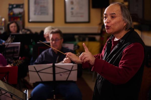 Composer Dr. Yuanlin Chen co<em></em>nducting the NY Mandolin Orchestra.