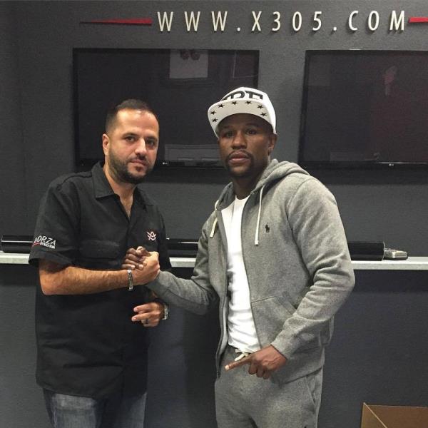 Vega with boxing legend Floyd Mayweather.