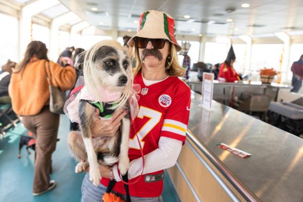 A dog dressed as Taylor Swift with an owner dressed as Travis Kelce.