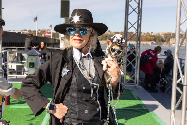 A dog owner and her pooch dressed up as cowgirls. 