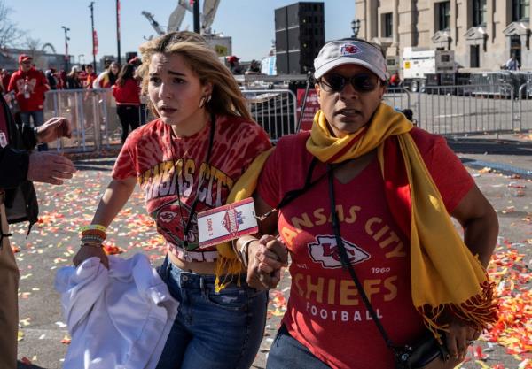 People flee after shots were fired during the parade.