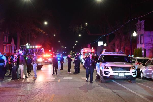 Chicago Police at the scene of wher<em></em>e an 8-year-old girl was killed and 10 other people were wounded in a mass shooting on the city's South Side on April 13, 2024.