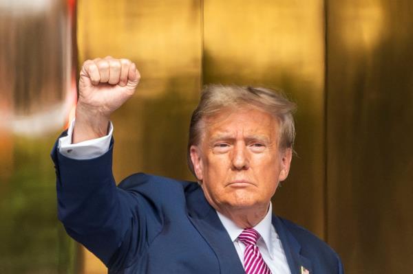 Do<em></em>nald Trump gesturing as he arrives at Trump Tower for his trial over charges of falsifying business records, in New York City