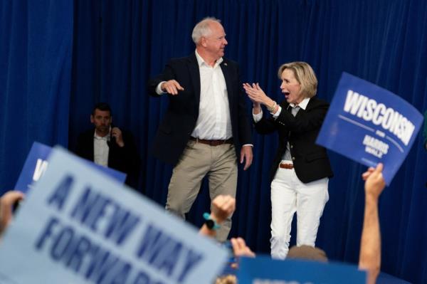 Vice presidential candidate Gov. Tim Walz and his wife Gwen Walz taking the stage at a rally in Superior, Wisco<em></em>nsin on Sept. 14, 2024.