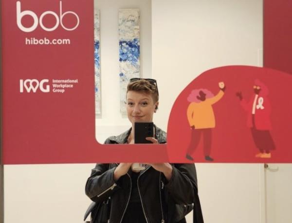 Picture of Sarah Reynolds in mirror selfie. She has short red hair and is wearing a leather jacket