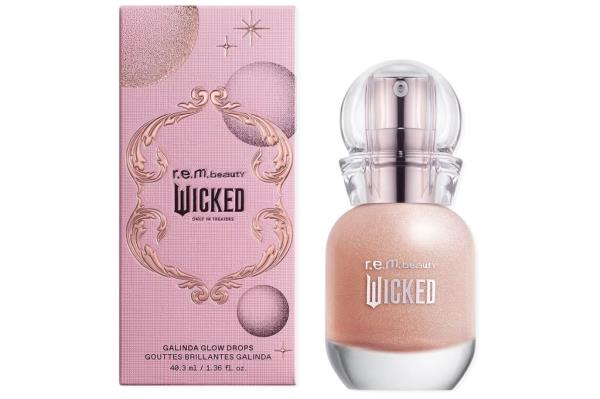 A pink bottle of liquid next to a matching pink box