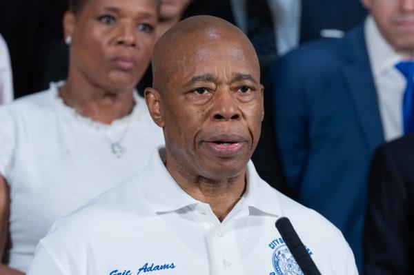 Mayor Eric Adams delivering a speech at City Hall, advocating for unity and peaceful political process amidst violent extremism.