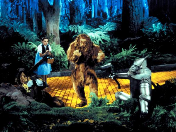Cowardly Lion walking down the yellow brick road.