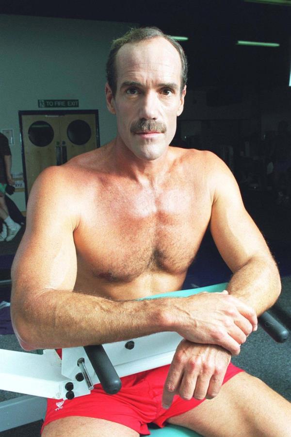 Michael Newman shirtless, smiling. 