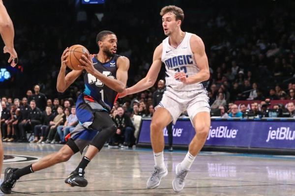Mikal Bridges, who scored 42 points, drives past Franz Wagner in the fourth quarter of the Nets' 129-101 win over the Magic.