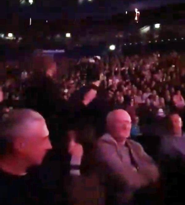 Crowd cheers as security boots the activist