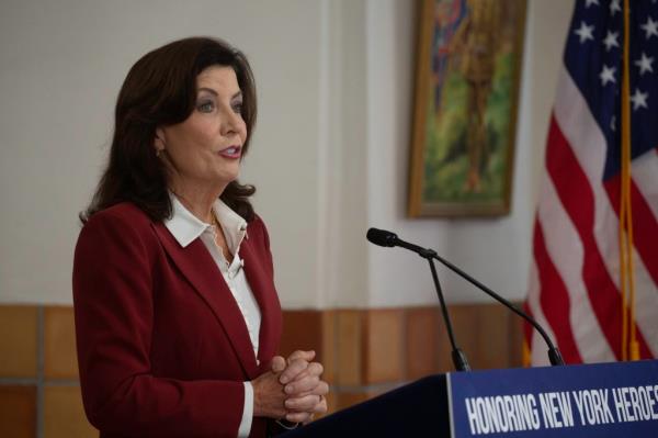 NY State Governor Kathy Hochul standing at the podium, ho<em></em>noring the Natio<em></em>nal Guard at the 369th Regiment Armory in Manhattan, NY.