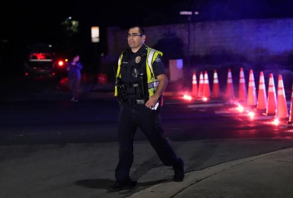 An Austin police officer works at the scene of a shooting in Southwest Austin on Tuesday, Dec. 5, 2023.