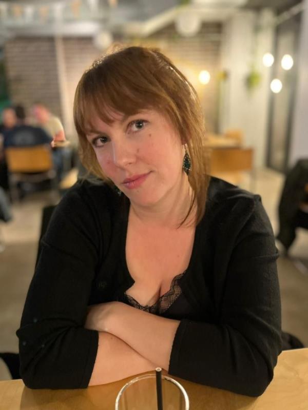 Michelle Morgan Davies at a restaurant, with her arms folded on the table.