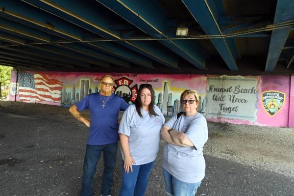 Eddie Earl (left), who power washes the mural day, posing along poop-covered walkway Wednesday with Howard Beach Lindenwood Civic Association Co-Presidents Phyllis Inserillo (center) and Barbara McNamara (right). 