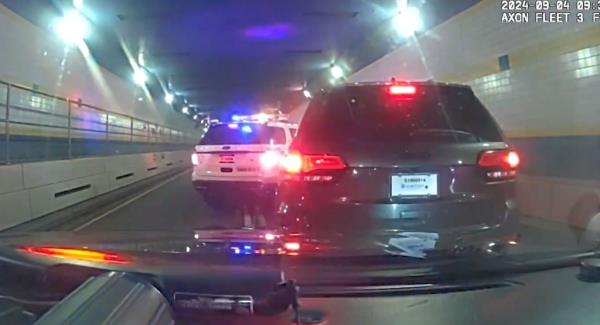 Police box the Jeep in the tunnel.