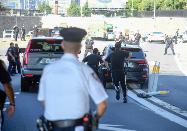 Officers running after the car.