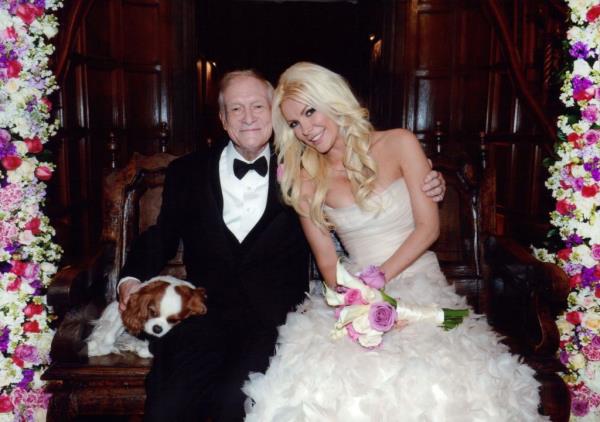 A young woman and an older man posing for a picture on their wedding day.