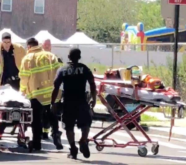 One of the kids on a gurney being loaded into an ambulance. 