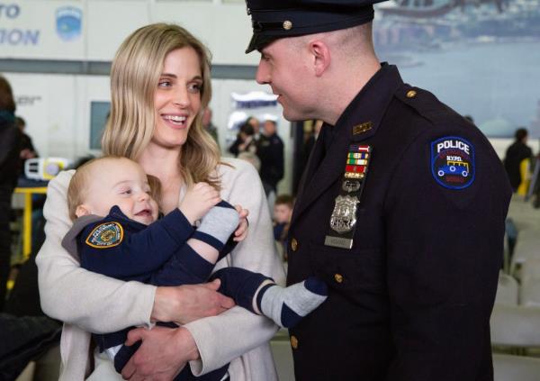 Joe Vigiano Jr with his wife and son during his NYPD graduation on March 10, 2023.