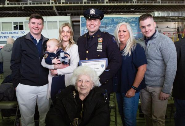 Joe Vigiano Jr. (C) with his wife, son, his mother Kathy Vigiano and his two brothers during his graduation on March 10, 2023.