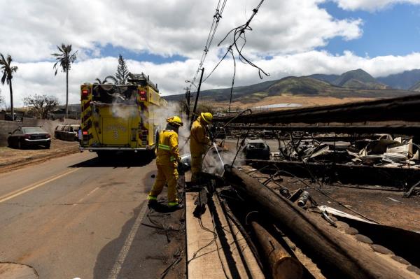 Firefighters put out a pocket of fire burning in a neighborhood destroyed by a wild fire in Lahaina.
