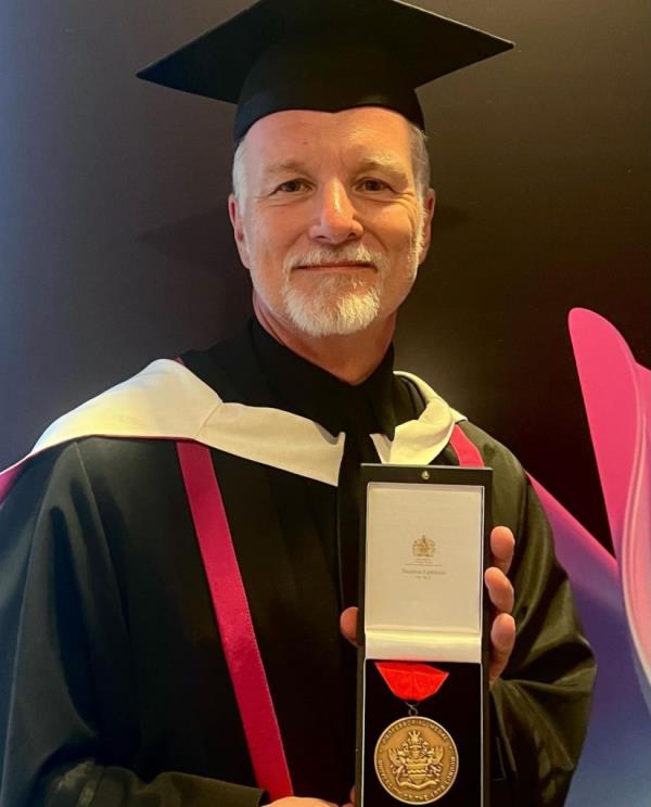 Paul Lowe receiving a professorial appointment at the University of Arts London.