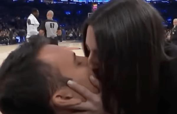 julius randle complains to a referee as an on-court proposal happens behind him.