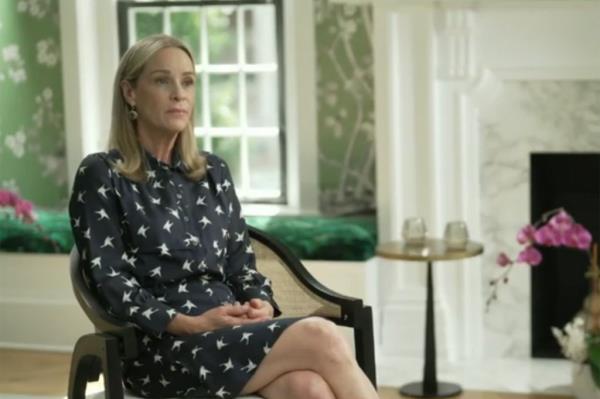 Kathleen Buhle sitting in a chair, legs crossed