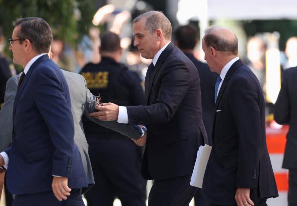 Hunter Biden in a suit walking into a court 