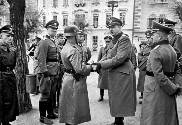 SS General Kurt Daluege do<em></em>nning traditio<em></em>nal uniform of the Third Reich as he visits German troops in Austria, in 1941.