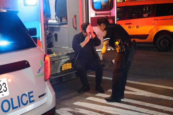 Another victim is seen being treated in an ambulance outside the store