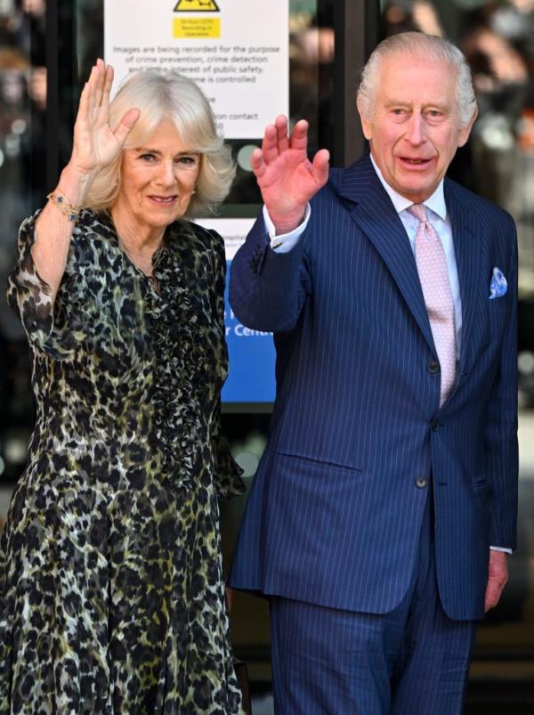King Charles III and Queen Camilla waving to well-wishers during their visit to the University College Hospital Macmillan Cancer Centre in London, England