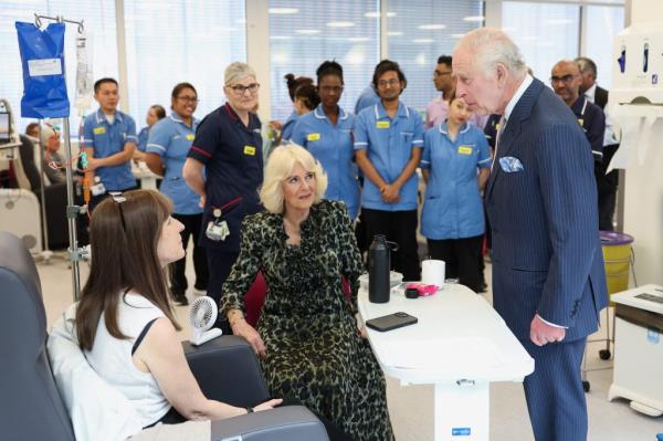King Charles III and Queen Camilla co<em></em>nversing with cancer patients and staff members during their visit to the University College Hospital Macmillan Cancer Centre in London, England