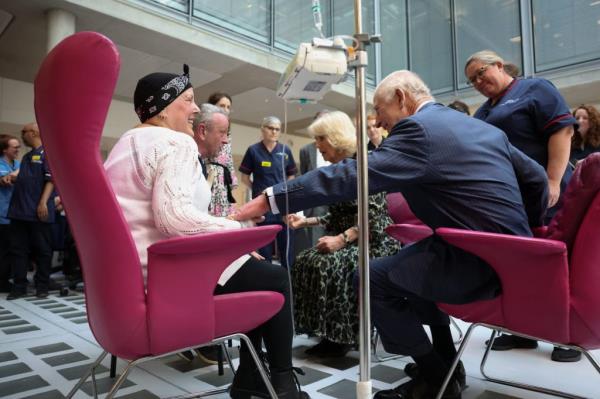 King Charles and Queen Camilla co<em></em>nversing with patient Lesley Woodbridge and her husband Roger at the University College Hospital Macmillan Cancer Centre in London
