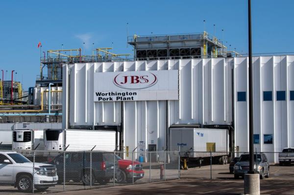 Large white building of JBS pork plant in Worthington, Minnesota.