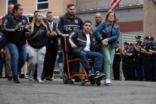 Officers Richard Yarusso and Christopher Abreu, who were shot during a wild chase June 3, walk out of a Queens hospital.