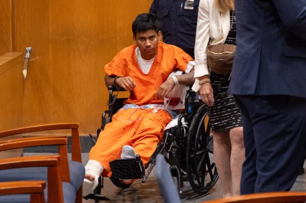 Bernardo Raul Castro Mata, a migrant, in a prison uniform at his arraignment in Queens Criminal Court, with Queens District Attorney Melinda Katz and PBA President Patrick Henry present.