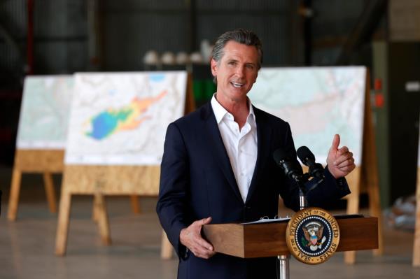 California Gov. Gavin Newsom delivers remarks to reporters after a helicopter tour with U.S. President Joe Biden of the Caldor Fire area, at Mather Airport on September 13, 2021 in Mather, California. Biden toured the wildfire-damaged area near Sacramento with Newsom before heading to Los Angeles to participate in a No on Recall campaign event.