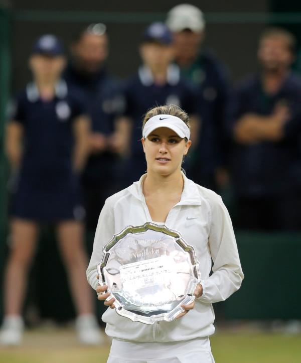 Eugenie Bouchard of Canada holds her runners-up trophy during the trophy ceremony after losing to Petra Kvitova of the Czech Republic in the women's singles final match at the All England Lawn Tennis Champio<em></em>nships in Wimbledon, London, Saturday, July 5, 2014. 
