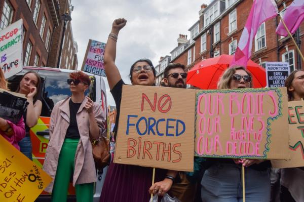 A pro-choice protester holds a placard which states 'No forced births' during a demo<em></em>nstration in Westminster.
