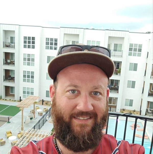 Ricky Johnson, a bearded man wearing a hat, is one of the three men found dead in Jordan Willis' backyard after a game day gathering.