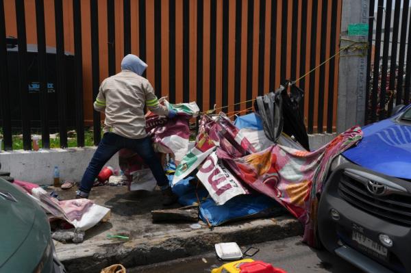 City workers dismantling an abando<em></em>ned makeshift camp known as 'Little Haiti' in the Tláhuac borough of Mexico City