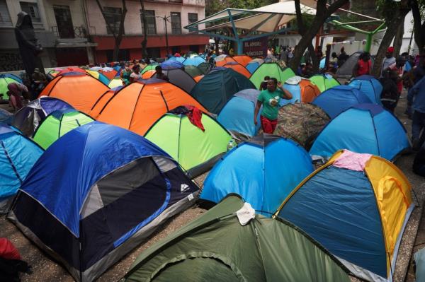 Haitian migrants camping at Giordano Bruno plaza in Juarez neighborhood of Mexico City, surrounded by tents before being cleared by federal immigration authorities