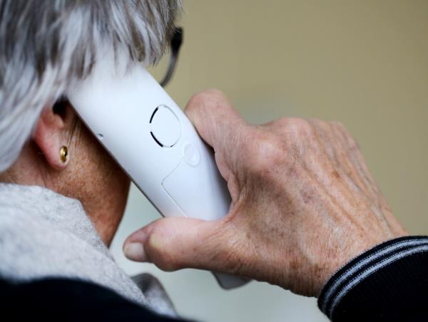Older person from behind talking on the phone