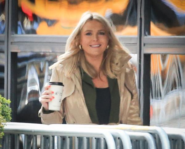 Press Secretary Karoline Leavitt leaving Trump Tower to attend Trump's hush mo<em></em>ney trial on April 25th, 2024, holding a coffee cup