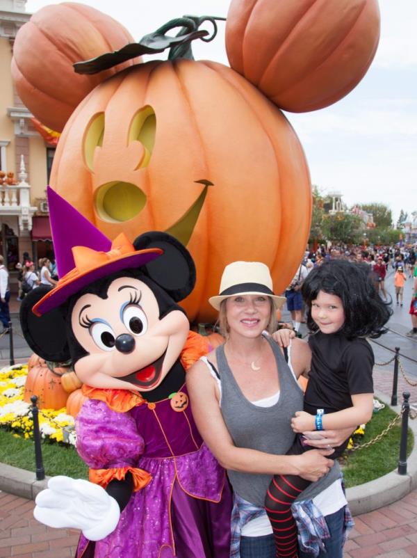 Christina Applegate and her daughter Sadie LeNoble posing with Minnie Mouse and a large pumpkin at Disneyland during Halloween Time celebration