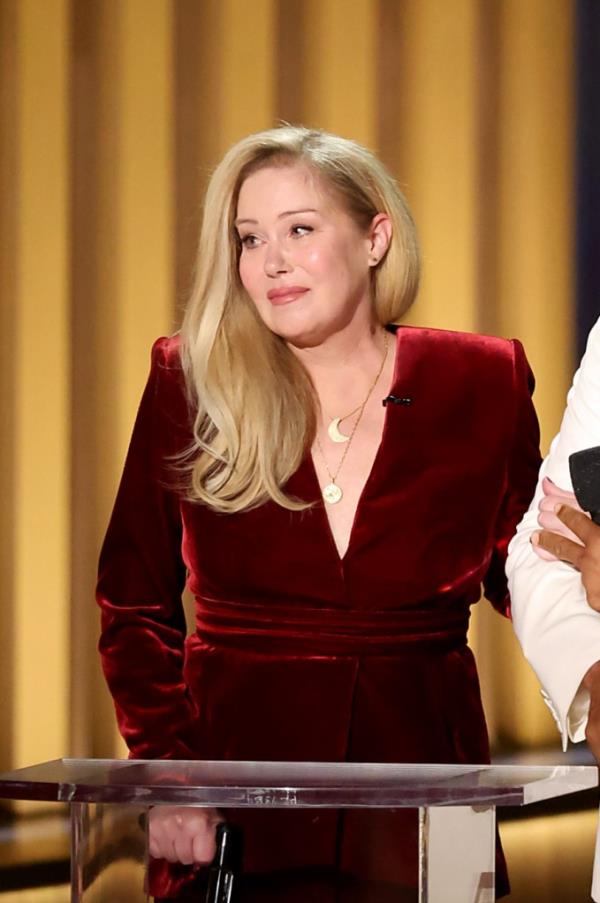 Christina Applegate speaking o<em></em>nstage during the 75th Primetime Emmy Awards in Los Angeles, wearing a red dress.
