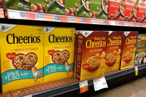 Cereal boxes of Cheerios and Ho<em></em>ney Nut Cheerios displayed on a store shelf