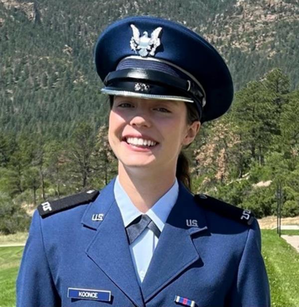 United States Air Force Academy Cadet 4th Class Avery Koo<em></em>nce smiles inher uniform with trees behind her.